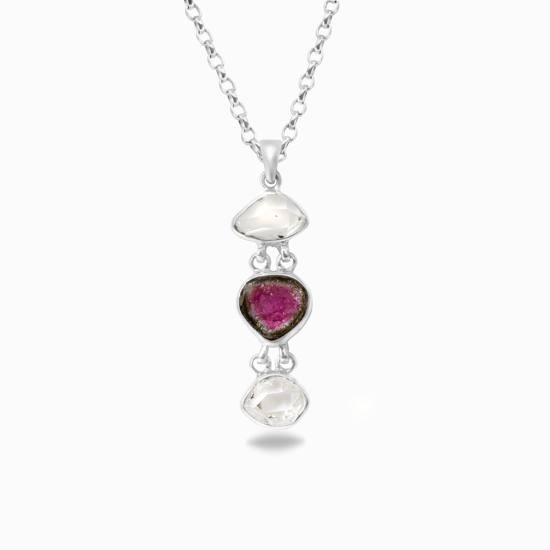 Silver necklace with pink, green and clear gemstones pendant on a white background