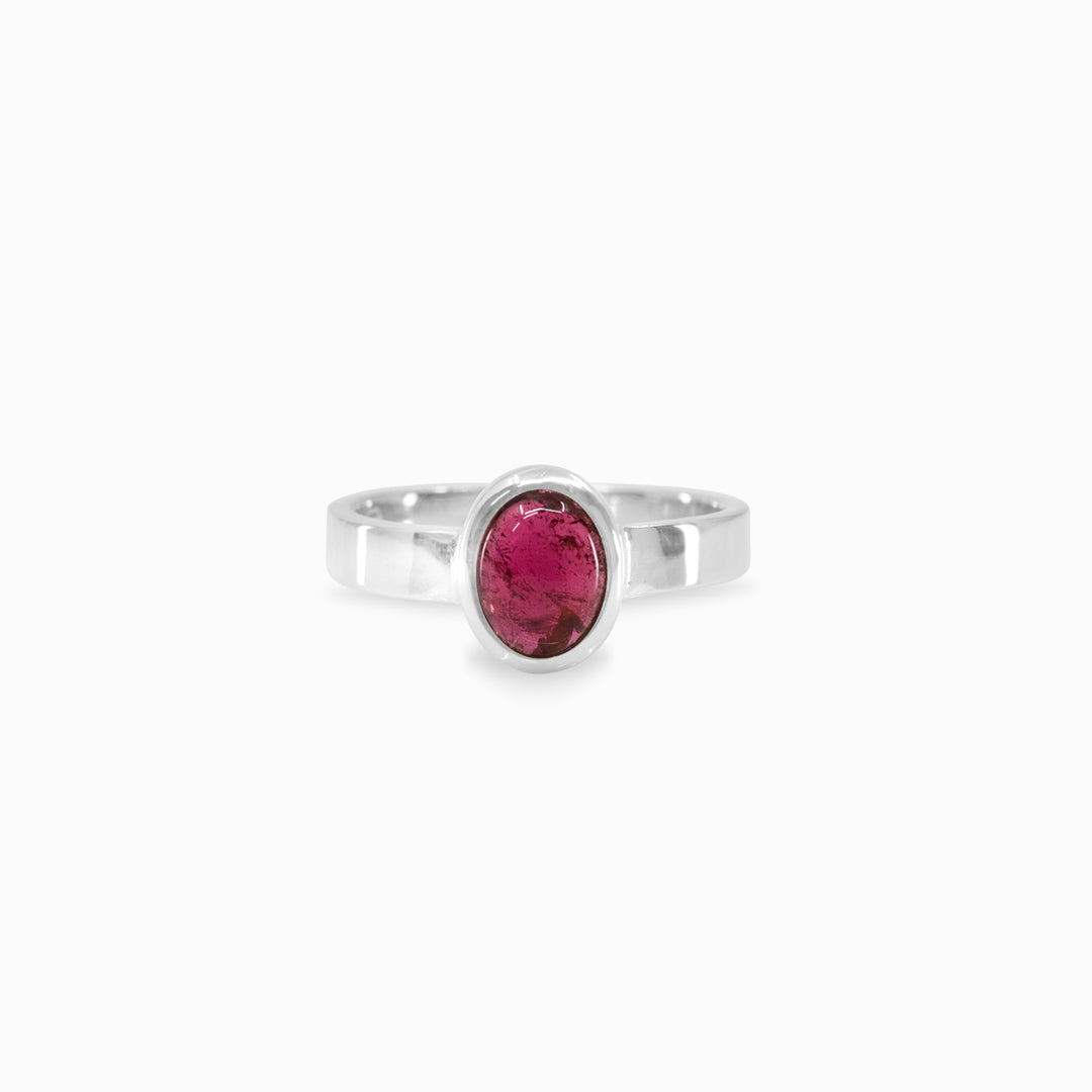 Silver ring with a pink gemstone on a white background