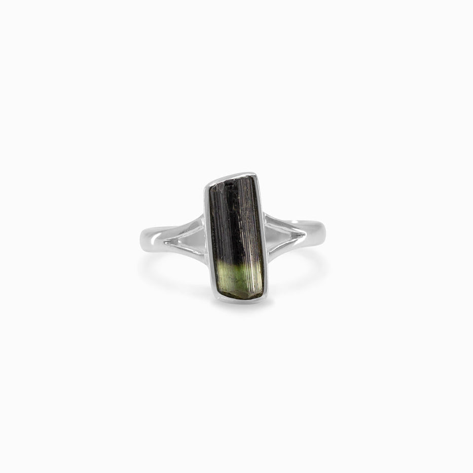 Silver ring with a green stone on a white background