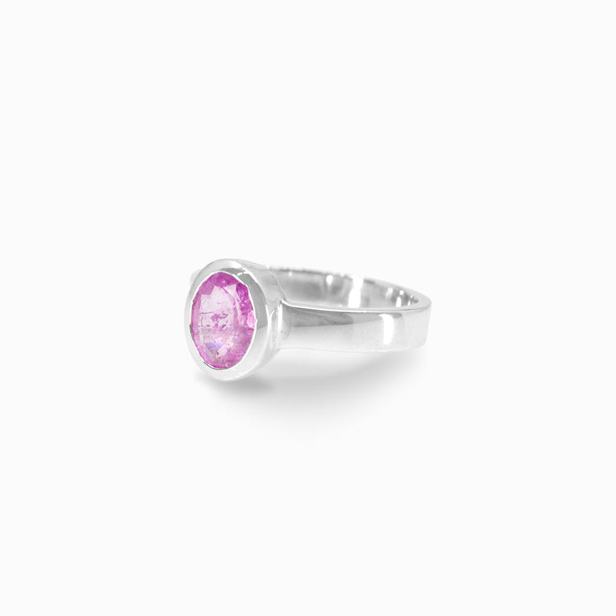 Silver ring with a pink gemstone on a white background