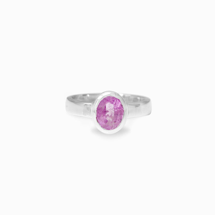 Silver ring with a pink gemstone on a white background