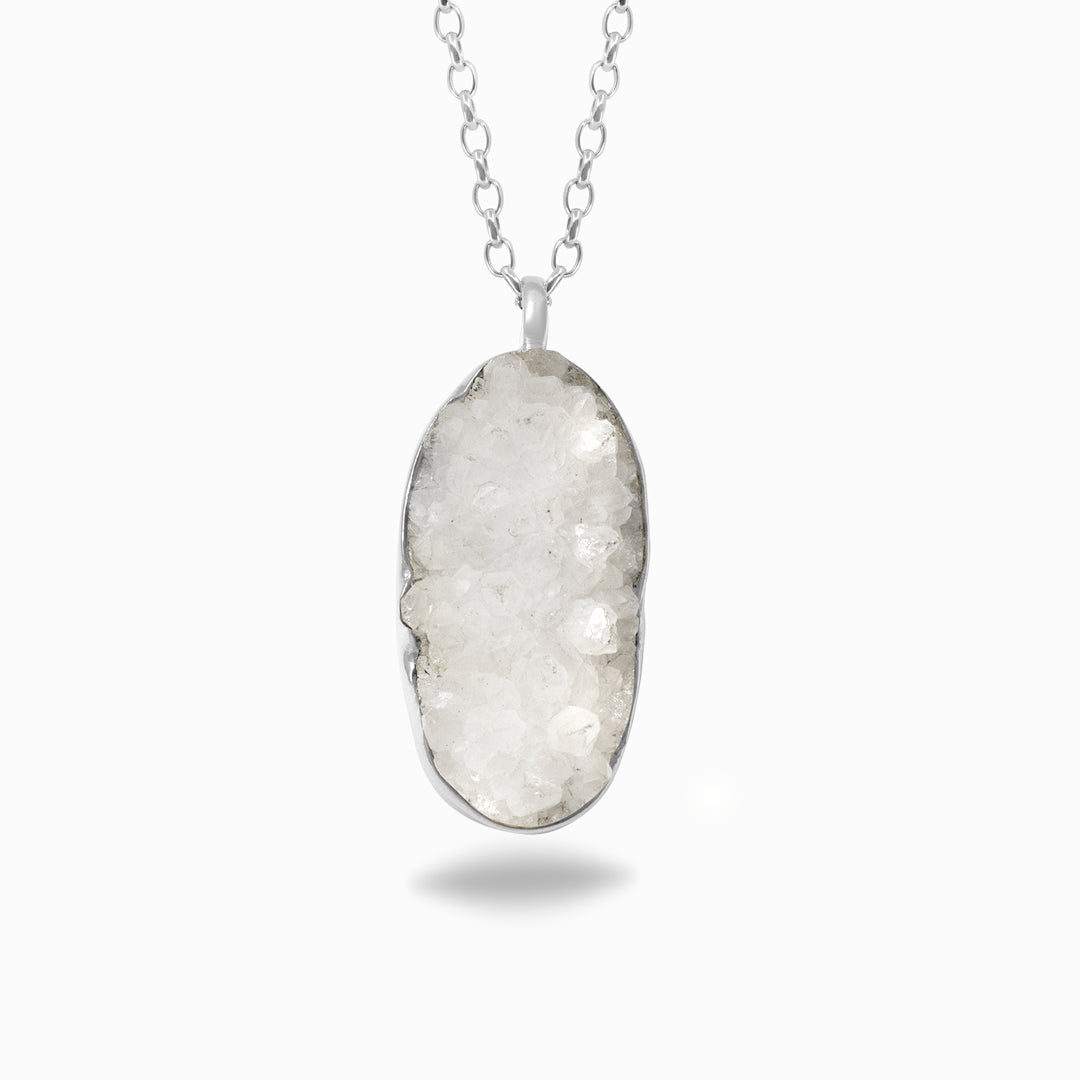 Silver necklace with an oval-shaped druzy stone pendant on a white background