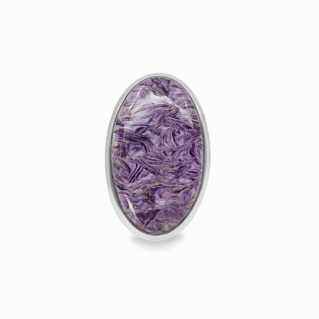 Silver ring with a purple gemstone on a white background