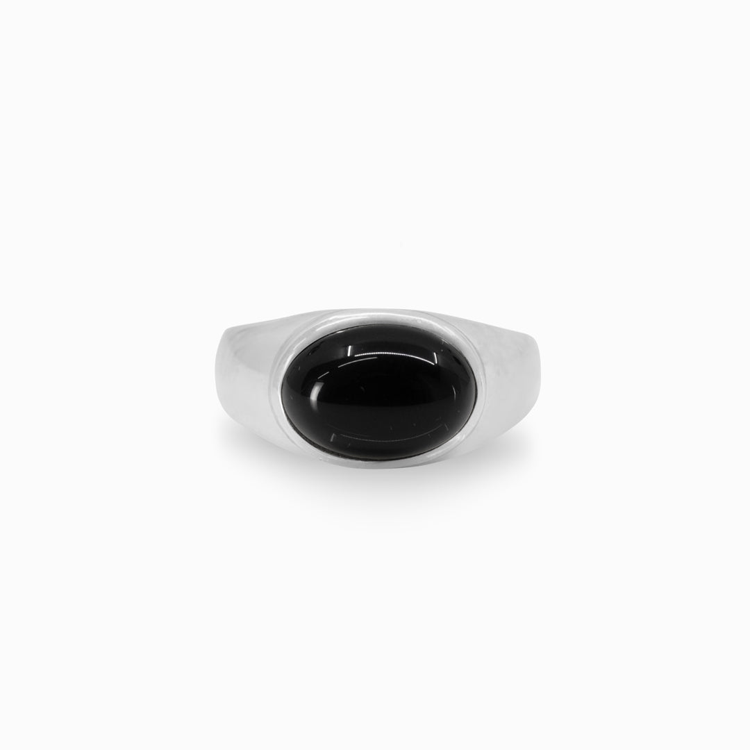 Silver ring with a black stone on a white background