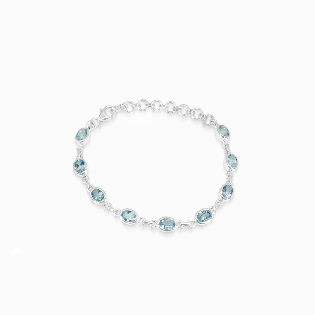 Silver bracelet with blue gemstones on a white background