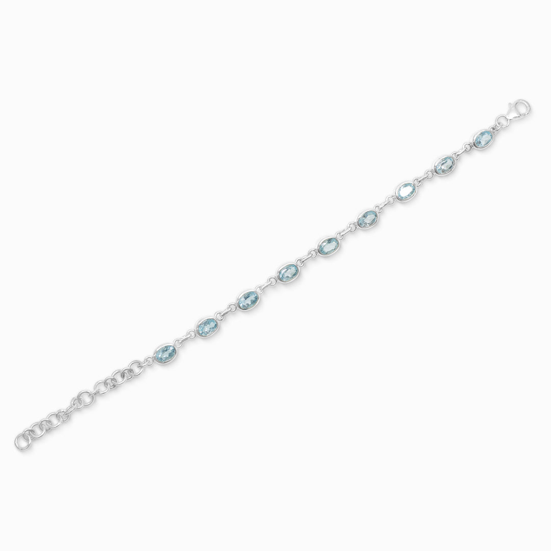 Silver bracelet with blue gemstones on a white background