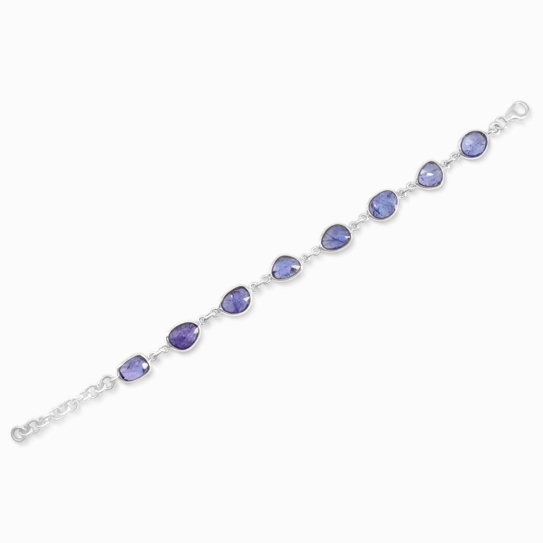 Silver bracelet with blue gemstones on a white background