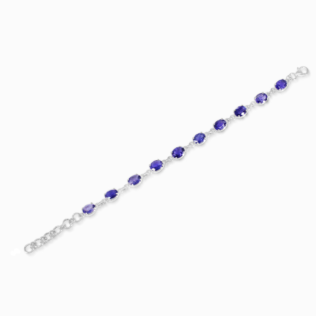 Silver bracelet with blue gemstones on a white background