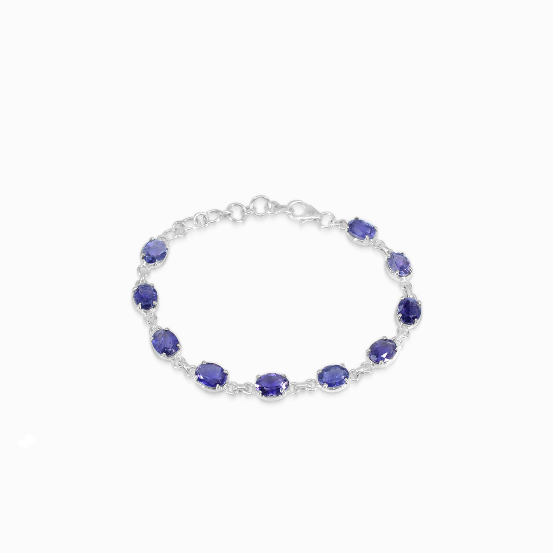 Silver bracelet with blue gemstones on a white background
