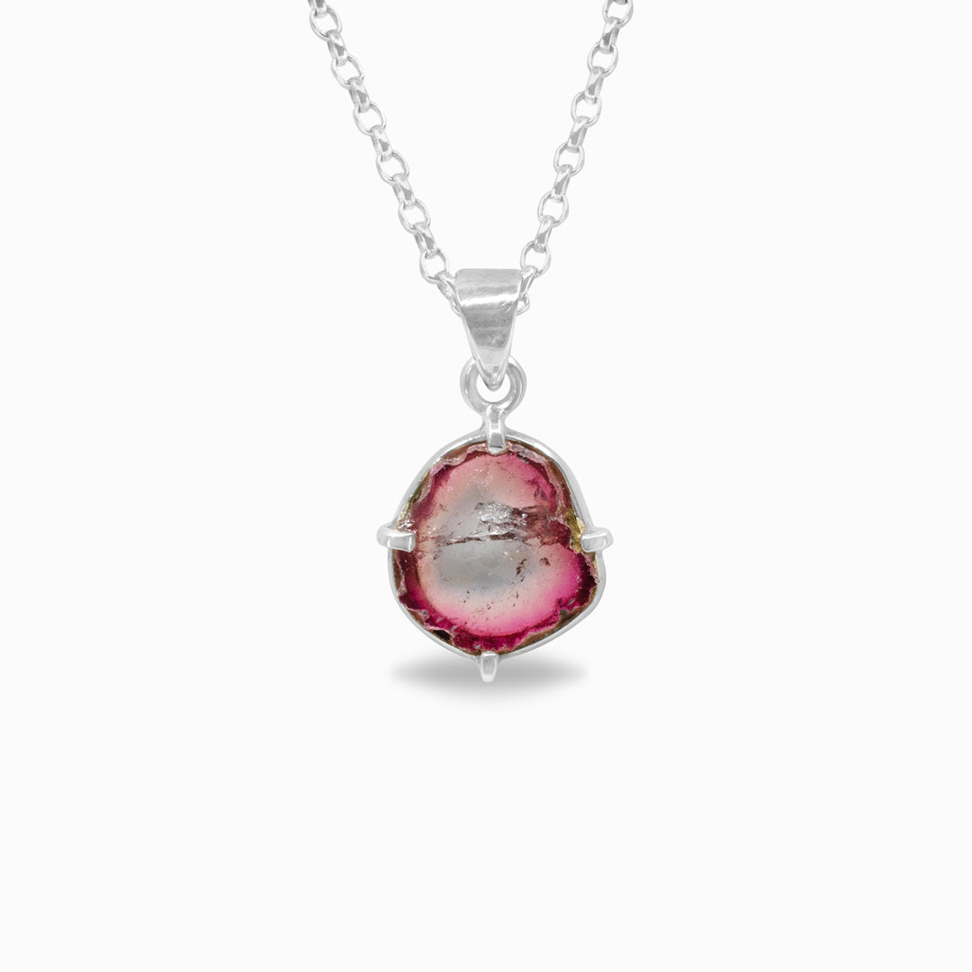 Silver necklace with a pink and green gemstone pendant on a white background