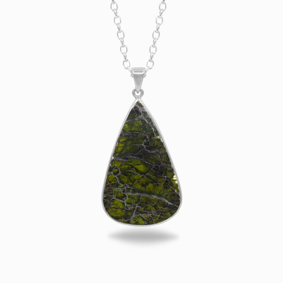Teardrop-shaped green stone pendant on a silver chain against a white background