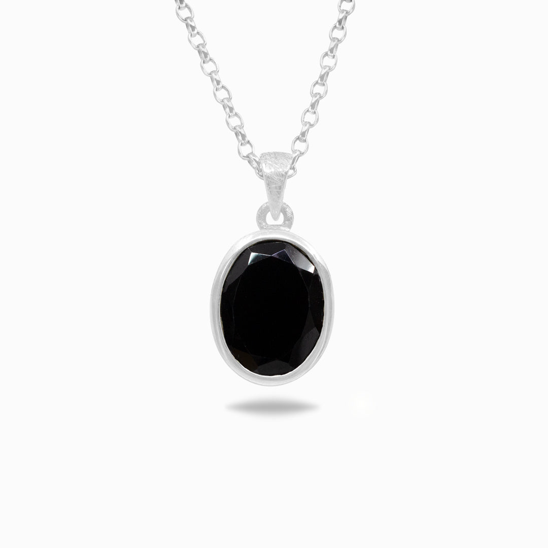 Silver necklace with a black pendant on a white background