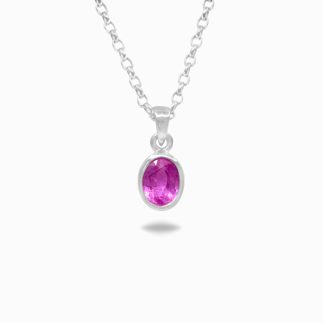 Silver necklace with a pink gemstone on a white background