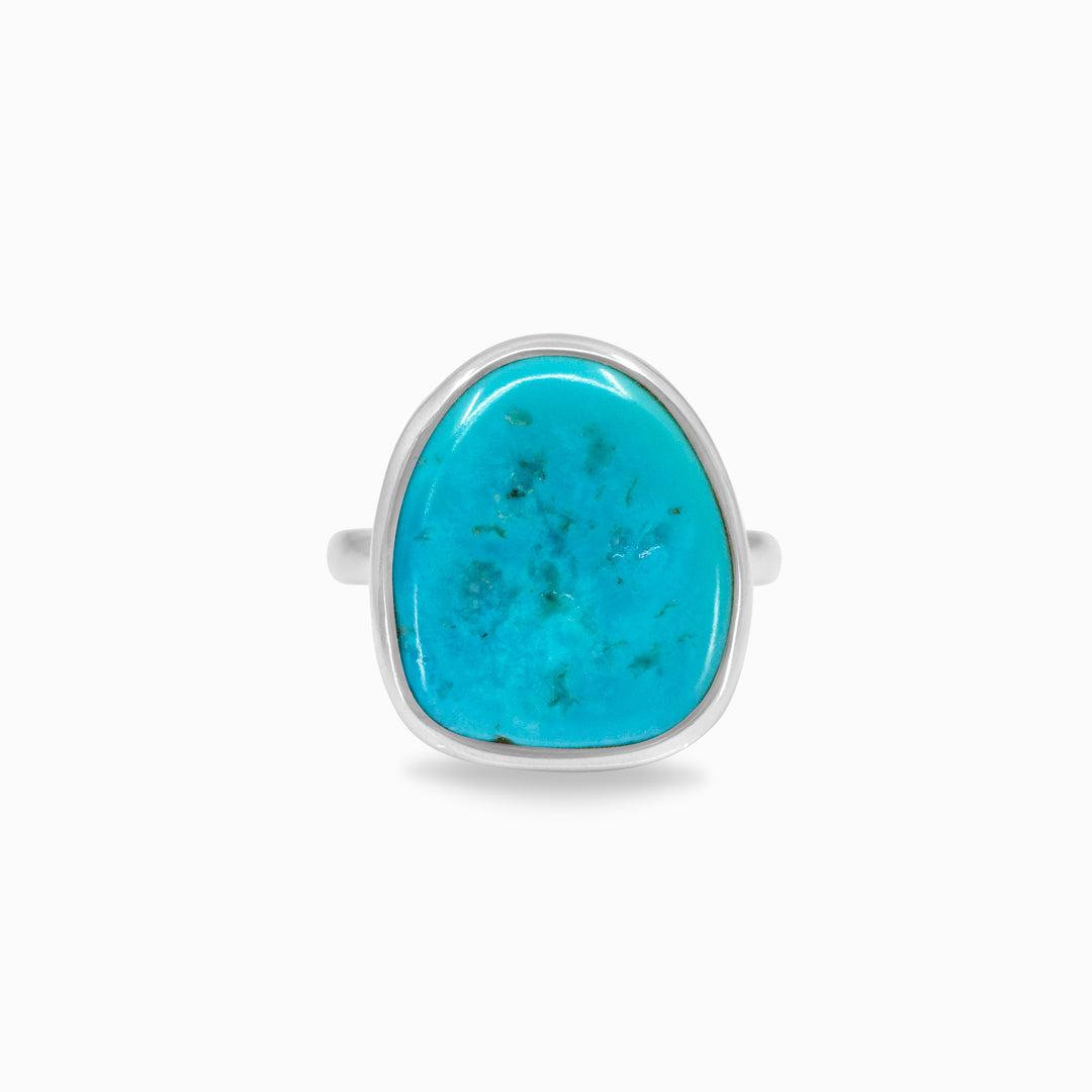 Silver ring with a blue gemstone on a white background