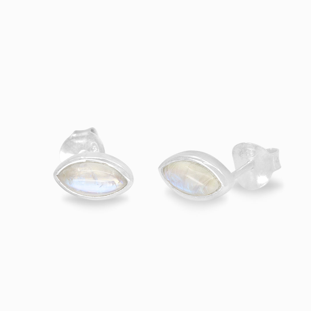 Pair of silver stud earrings with white gemstone on a white background