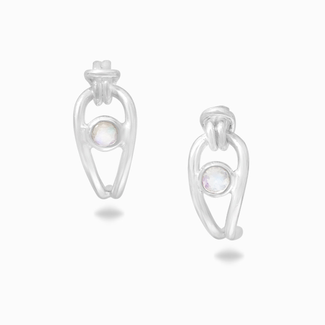 Pair of silver earrings with a white gemstone on a white background