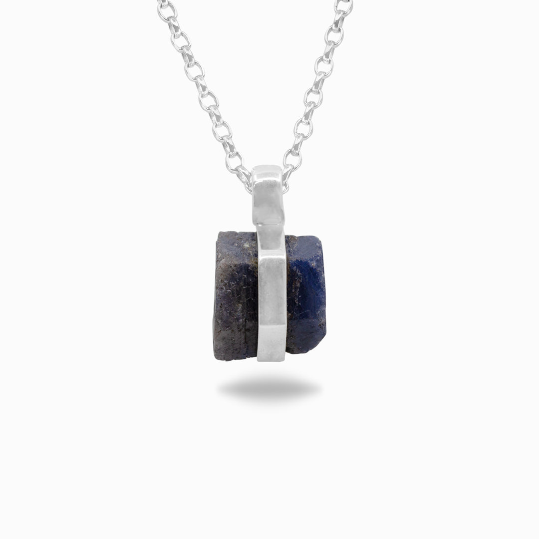 Silver necklace with a blue stone on a white background