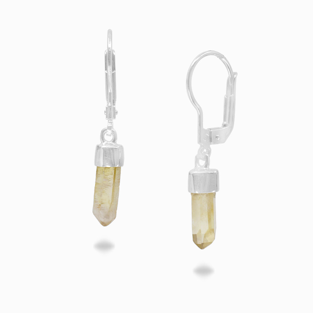 Silver drop earrings with a yellow stone on a white background