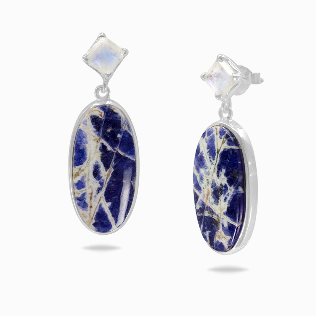 Pair of silver earrings with blue and white stones on a white background