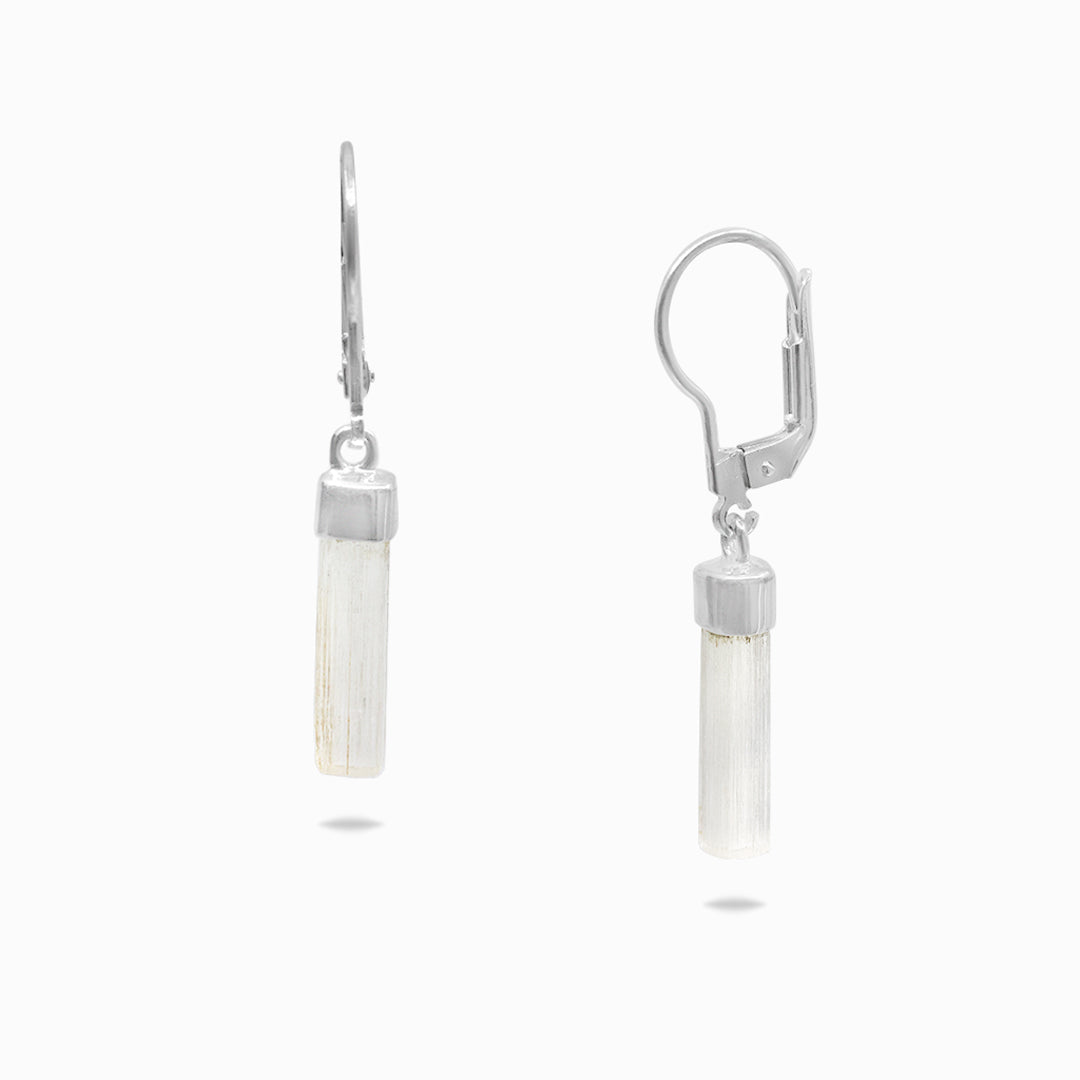 Pair of silver earrings with clear stones on a white background