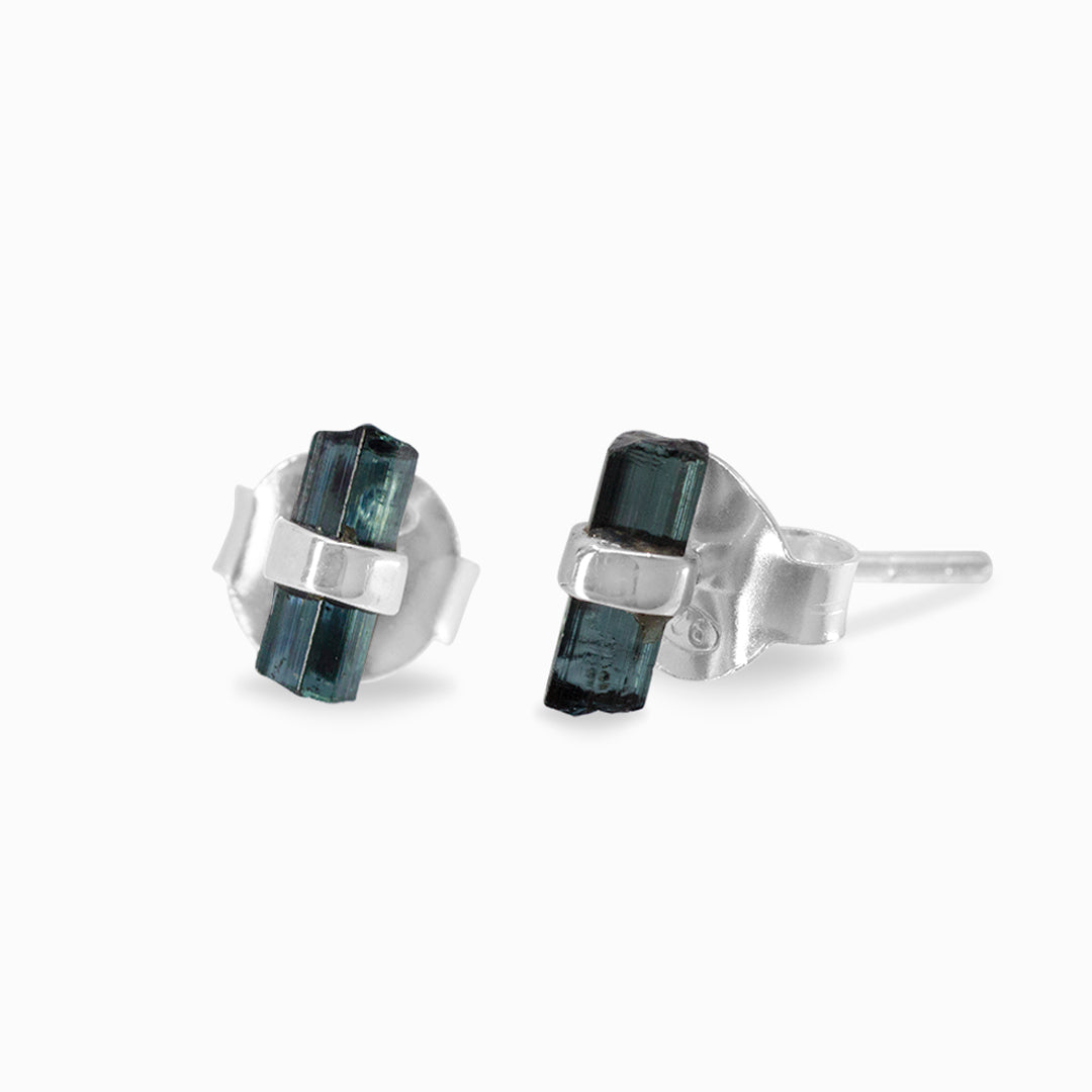 Pair of silver stud earrings with blue gemstones on a white background