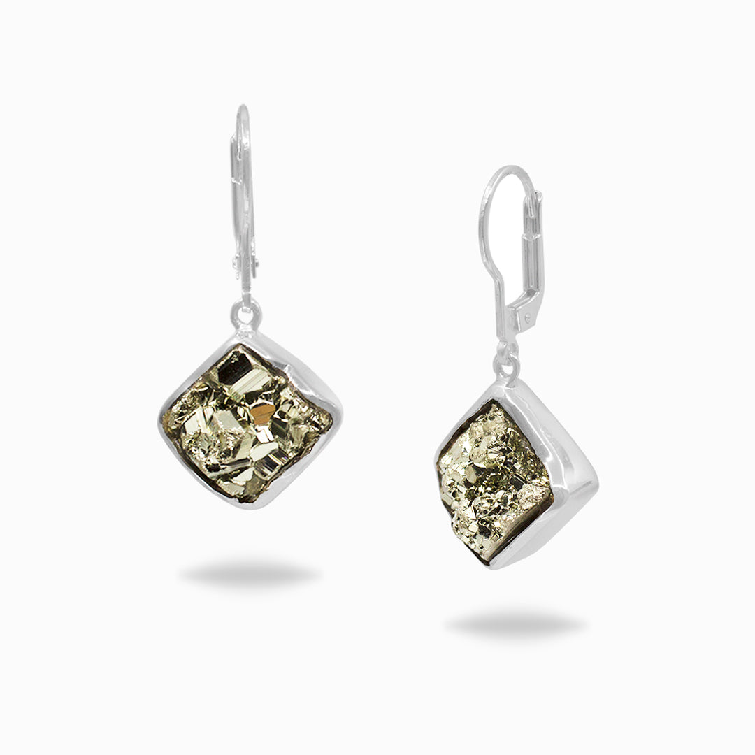 Pair of silver earrings with metallic gemstones on a white background
