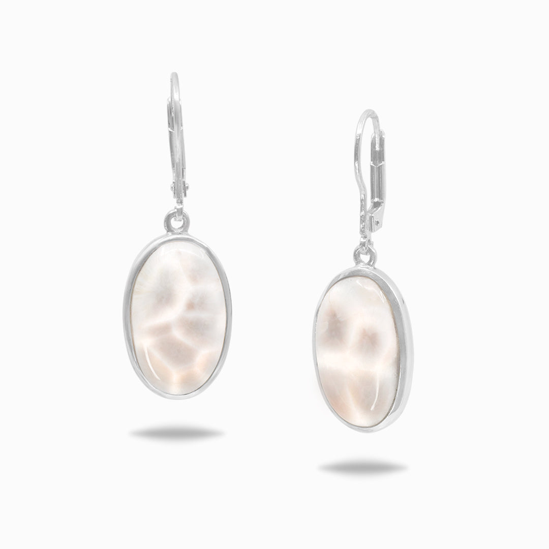 Pair of silver earrings with white and pink gemstones on a white background