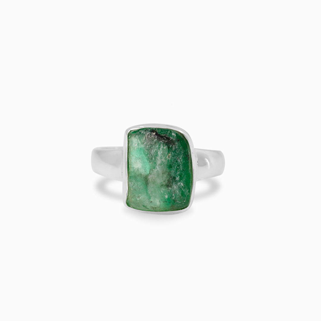 Silver ring with a green gemstone on a white background