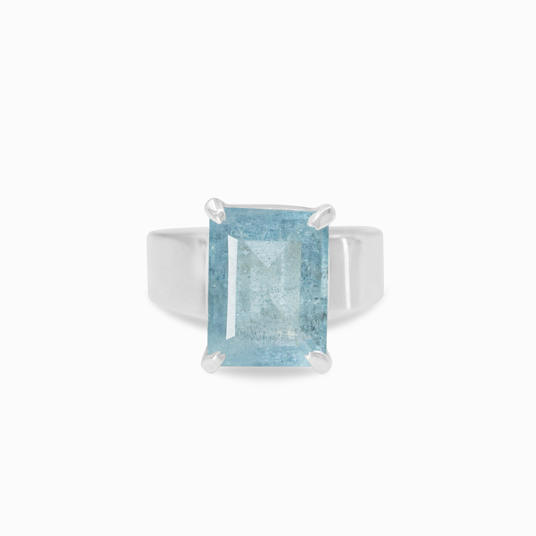 Silver ring with a rectangular blue gemstone on a white background