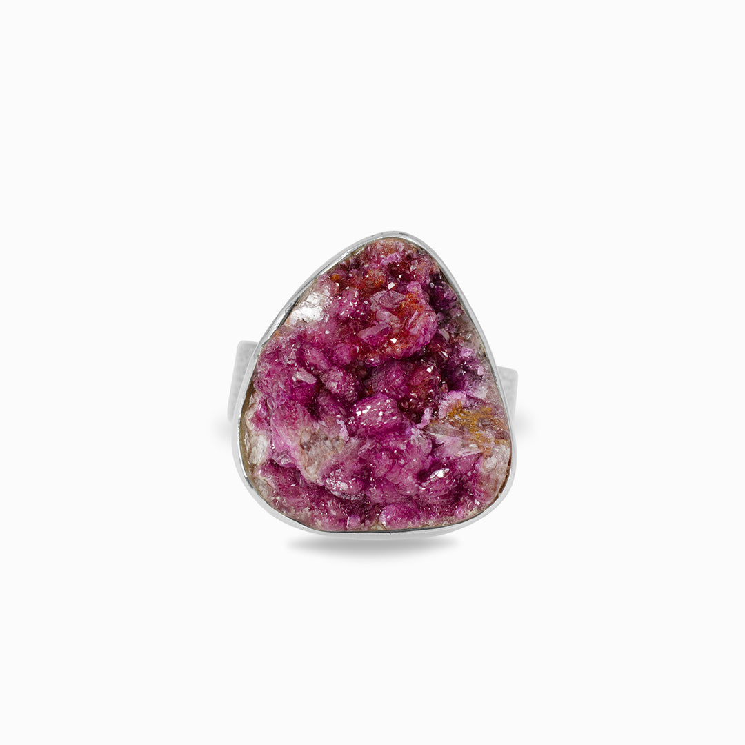 Silver ring with a pink gemstone on a white background