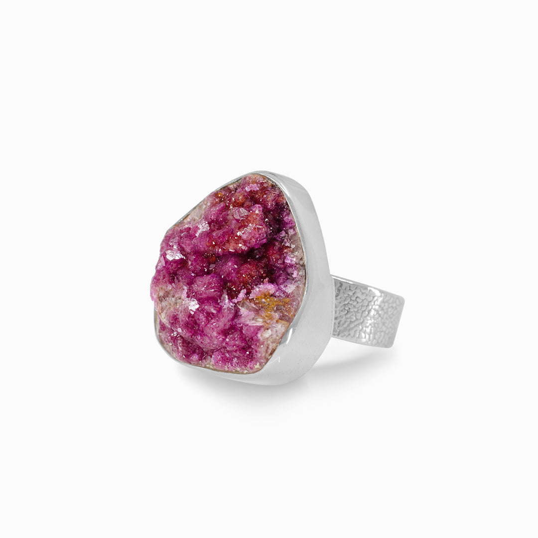 Silver ring with a pink gemstone on a white background