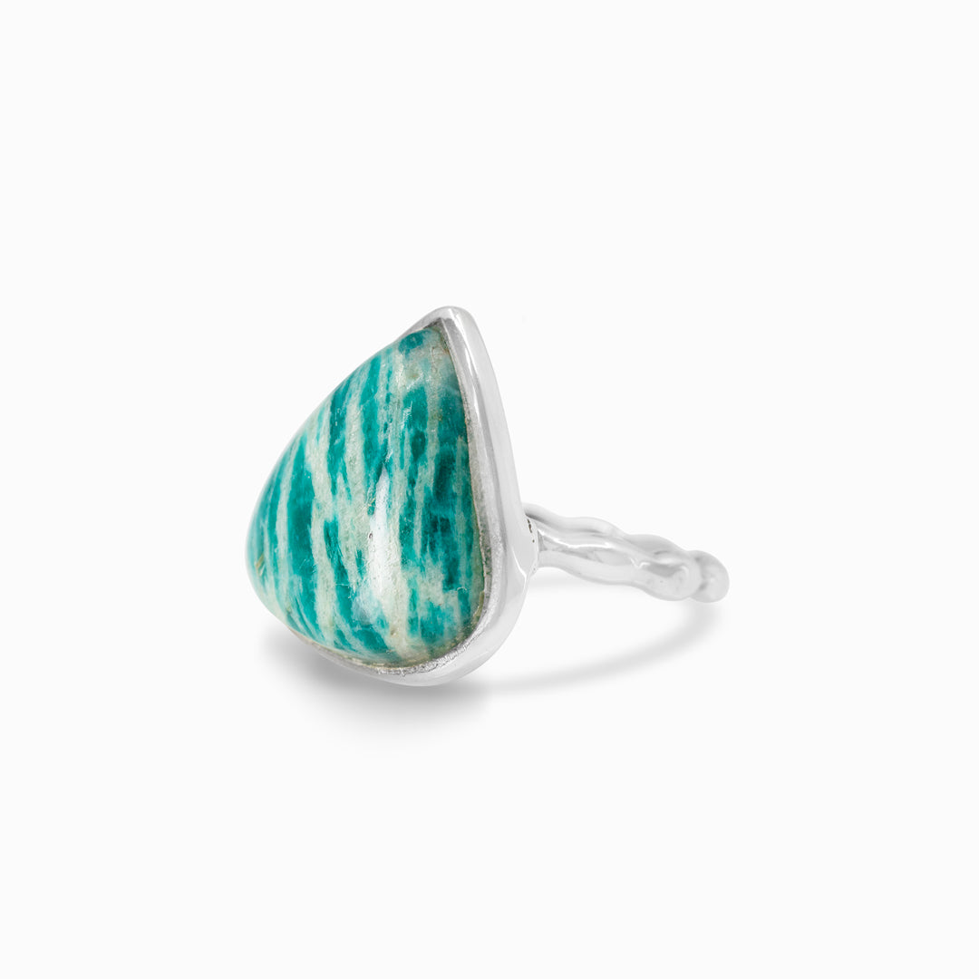 Teardrop-shaped silver ring with a green and white pattern on a white background