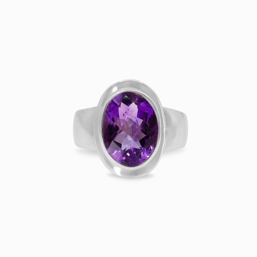 Silver ring with a purple gemstone on a white background