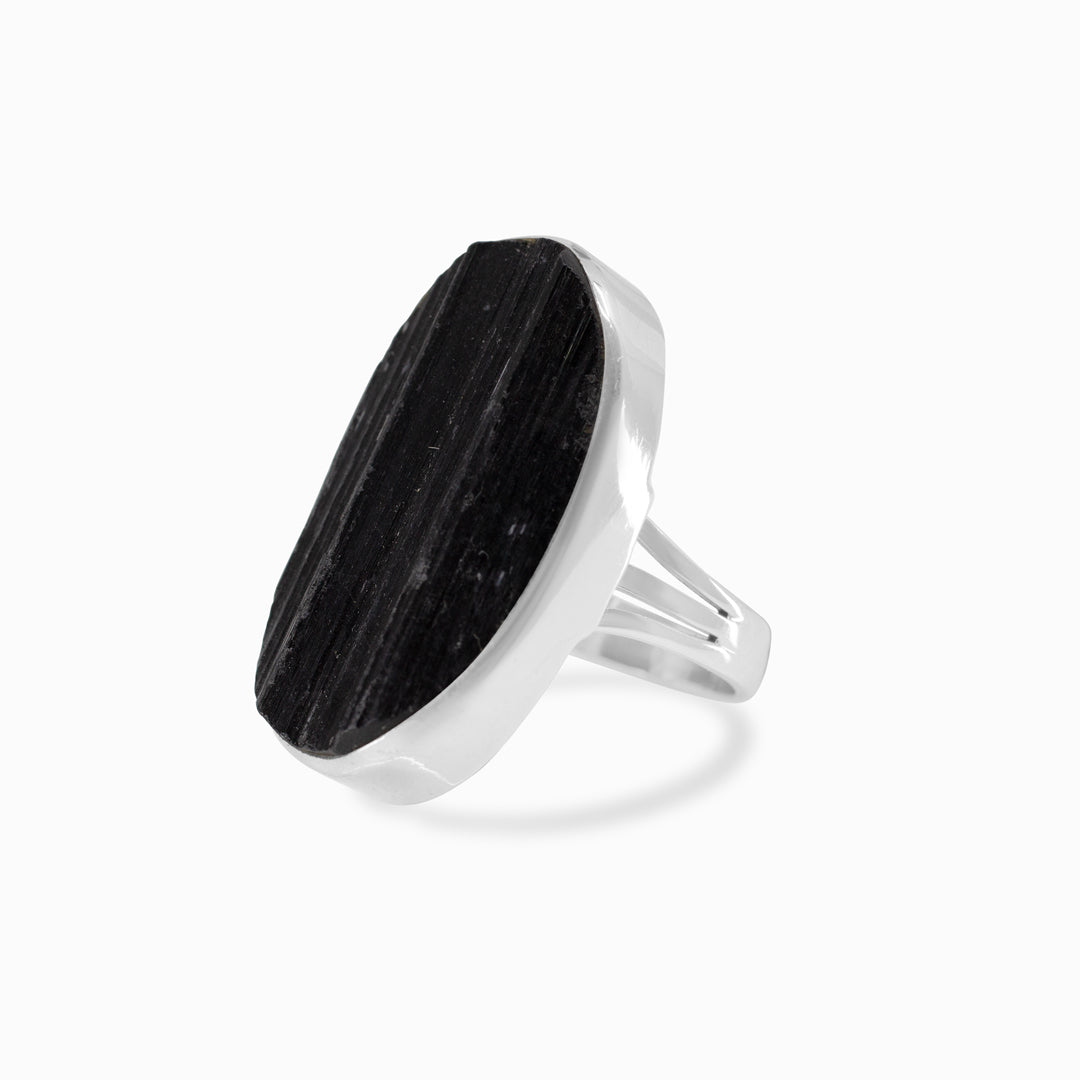 Silver ring with a black gemstone on a white background