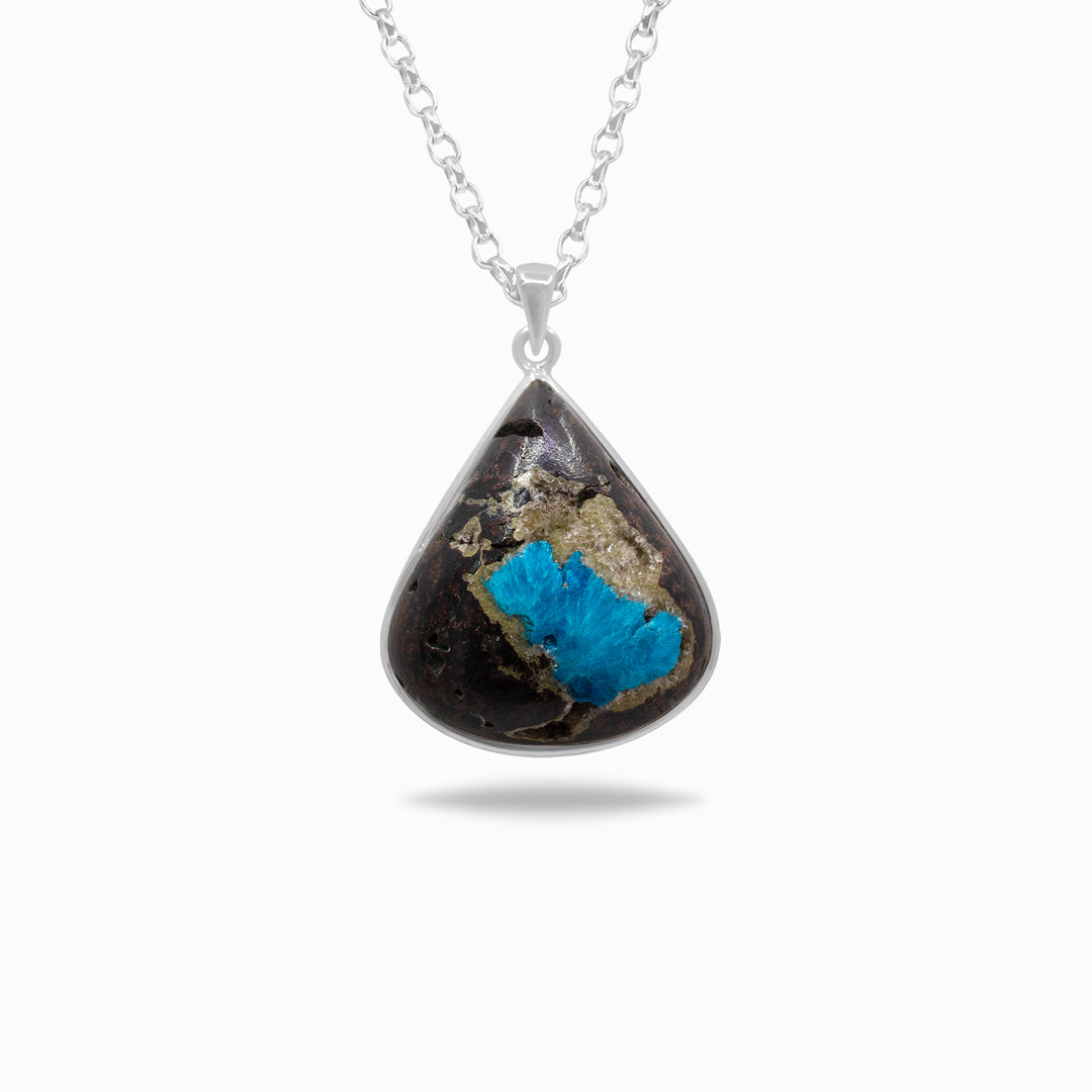Silver necklace with blue and brown gemstone on a white background