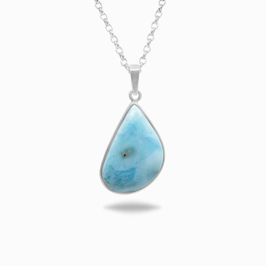 Silver necklace with a light blue and white stone on a white background