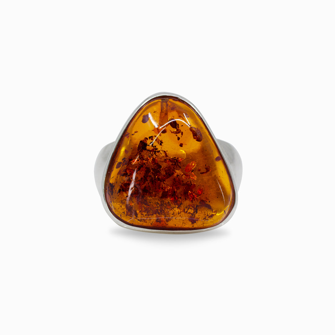 Silver ring with a amber stone on a white background
