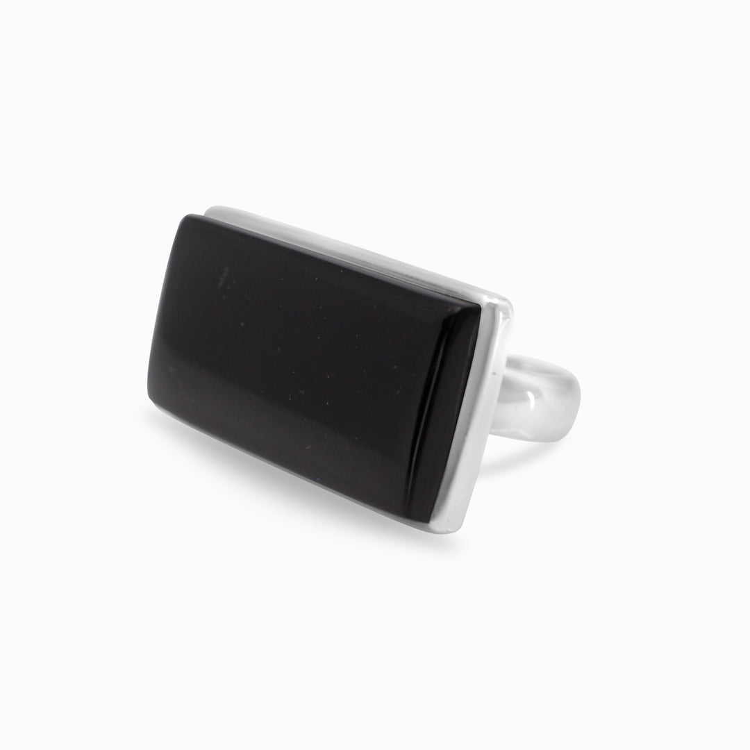Silver ring with a black gemstone on a white background