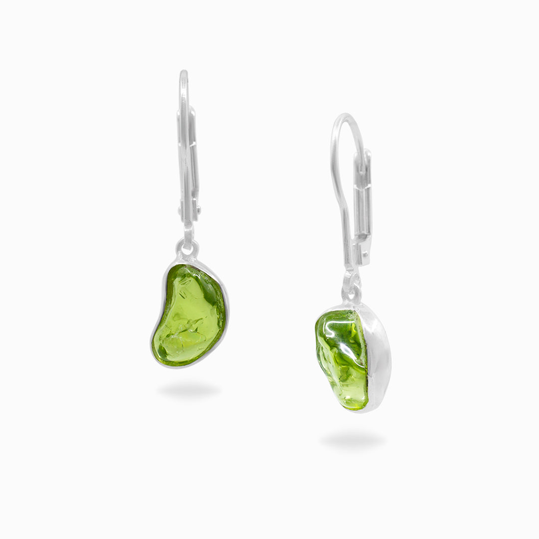 Pair of silver earrings with green gemstones on a white background