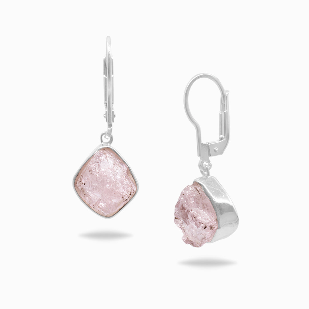 Pair of silver earrings with pink gemstones on a white background
