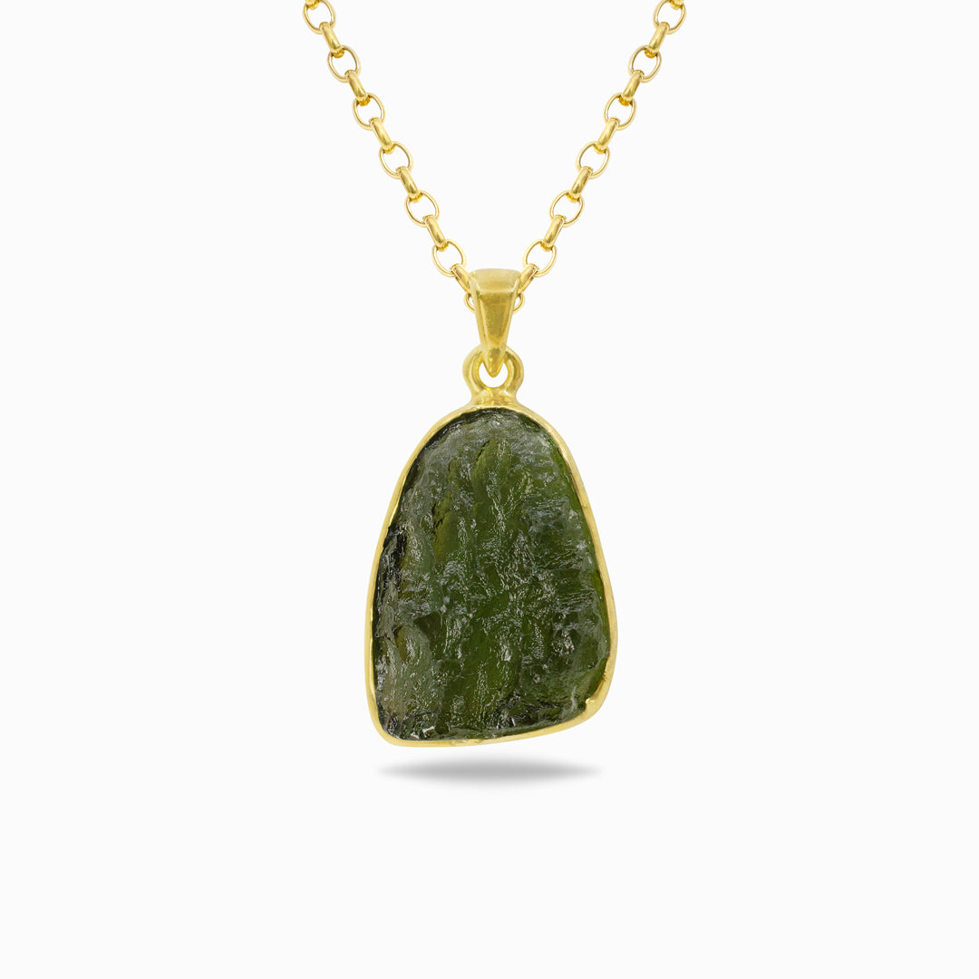 Golden necklace with a green stone on a white background