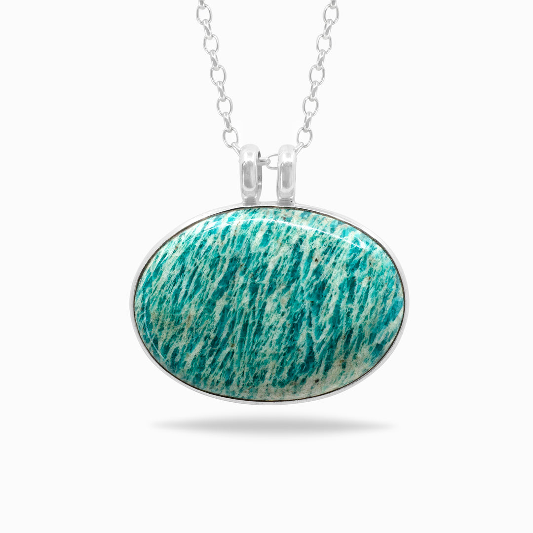 Silver necklace with a green and white stone on a white background