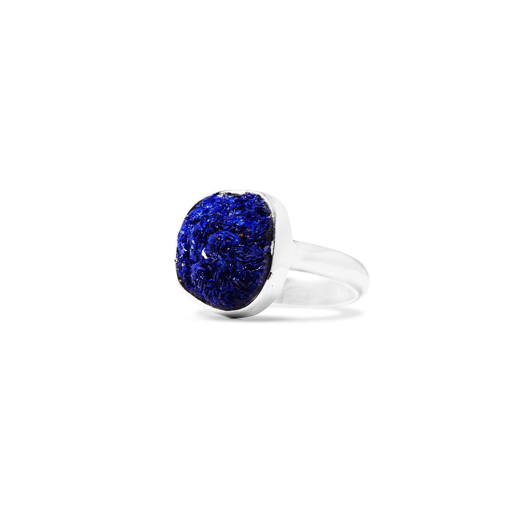 Silver ring with a navy blue gemstone on a white background