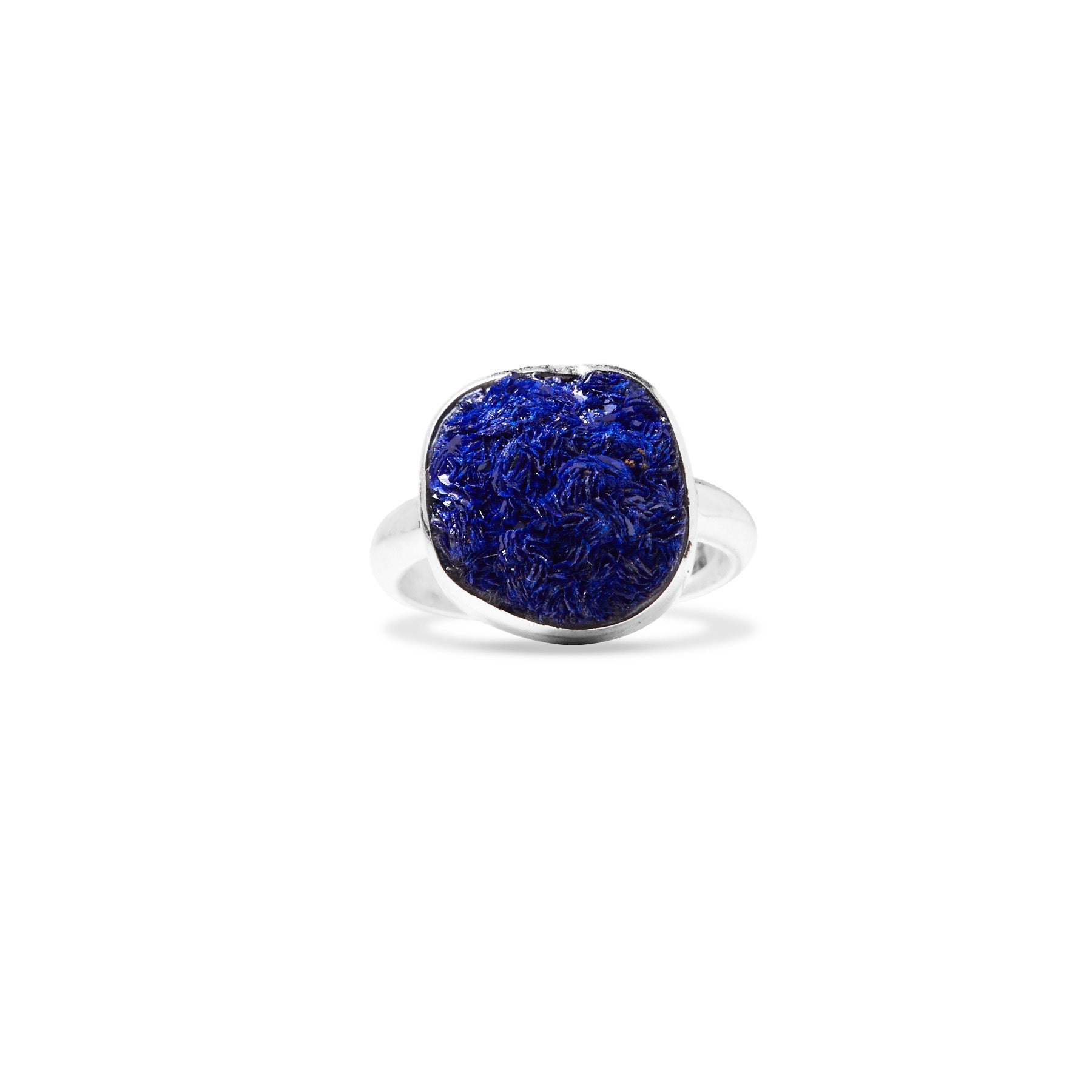 Silver ring with a navy blue gemstone on a white background