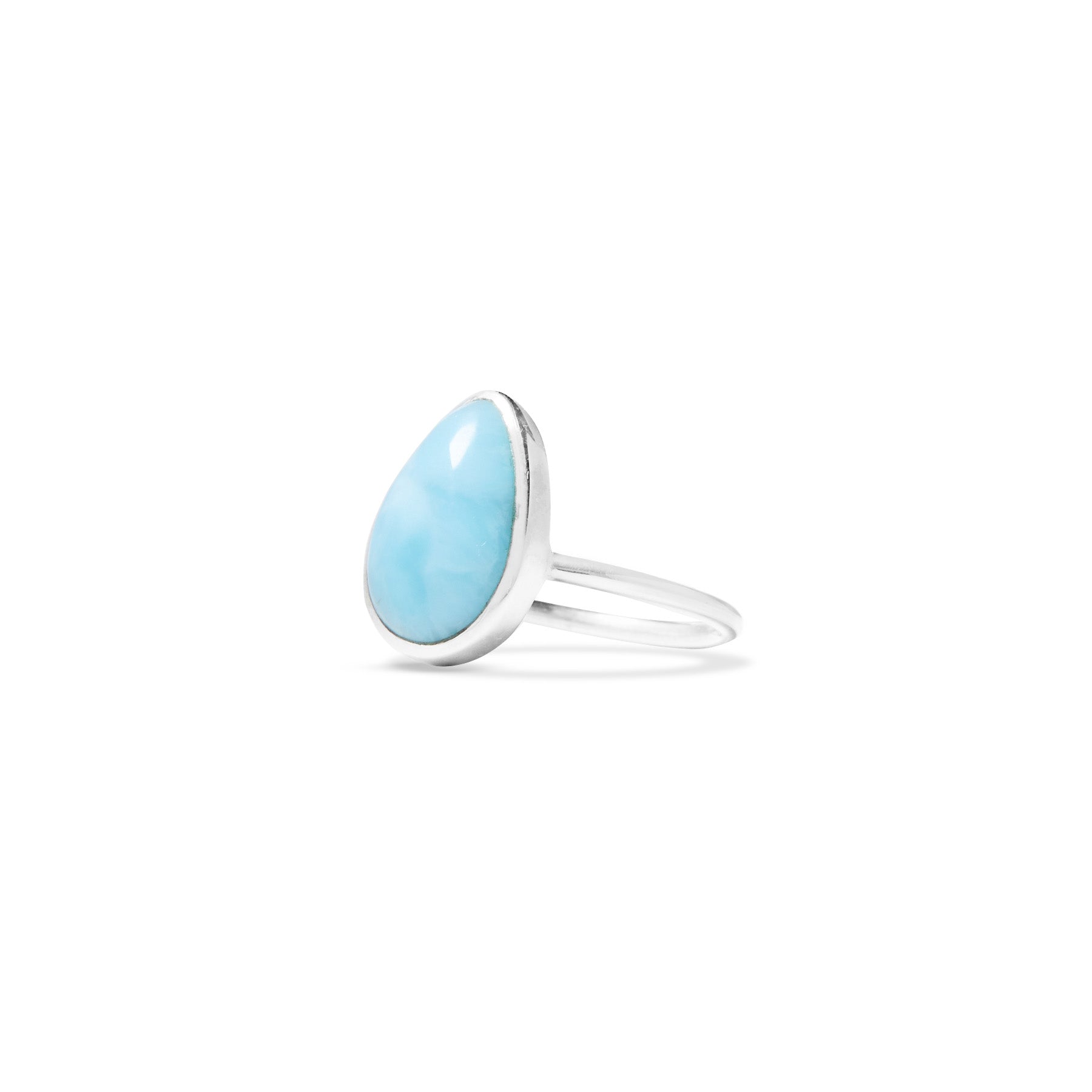 Silver ring with a light blue stone on a white background