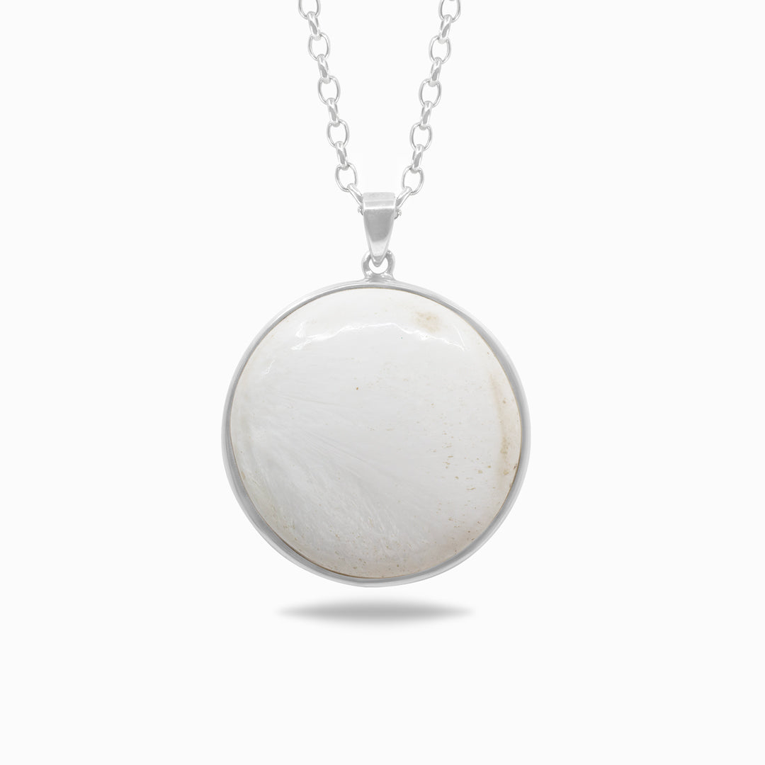 Silver necklace with a white stone pendant on a white background