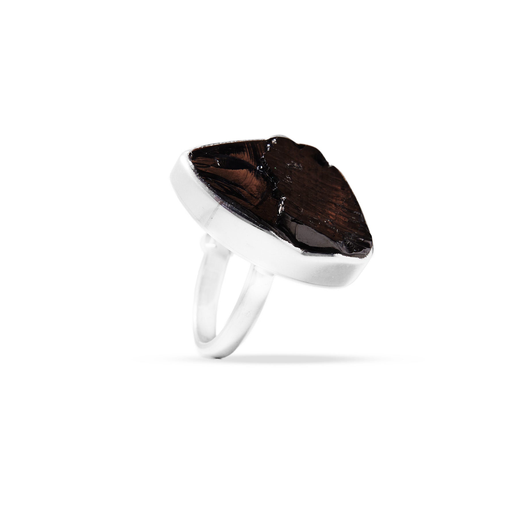 Silver ring with a freeform black metallic stone on a white background