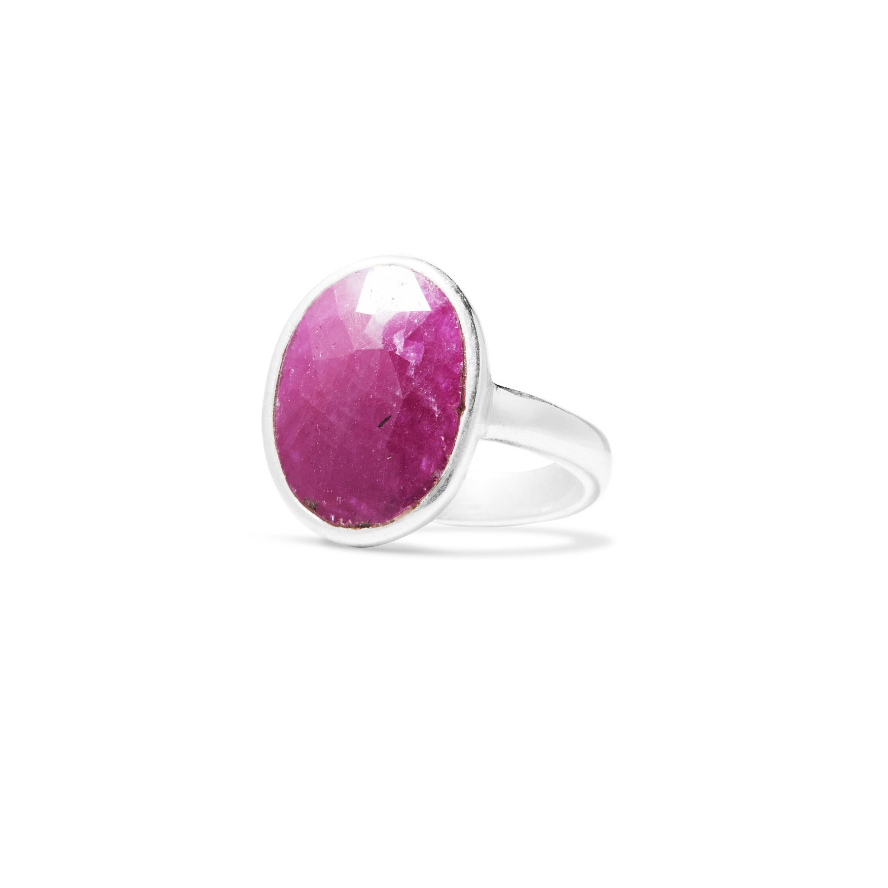 Silver ring with a dark pink gemstone on a white background.