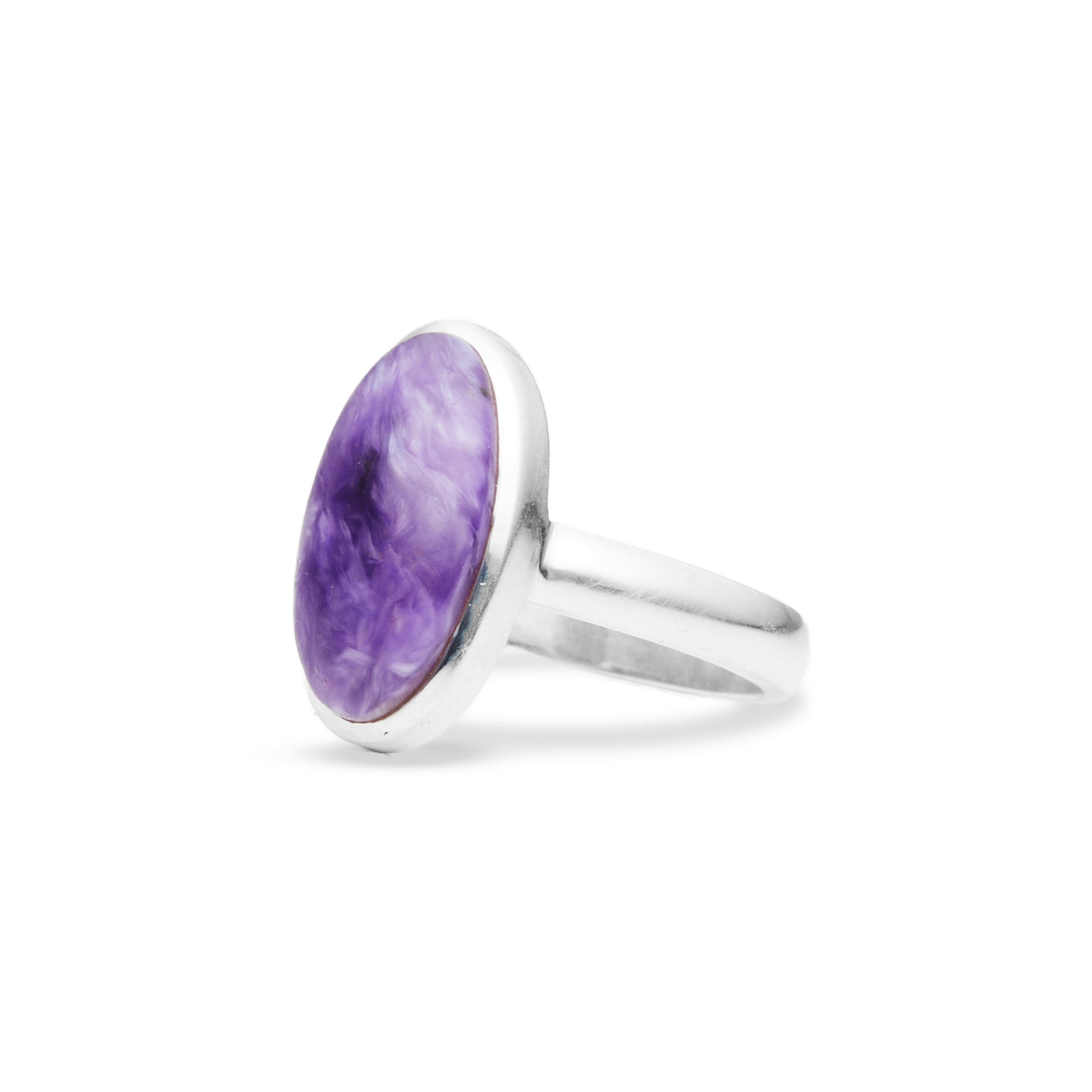 Silver ring with a purple gemstone on a white background