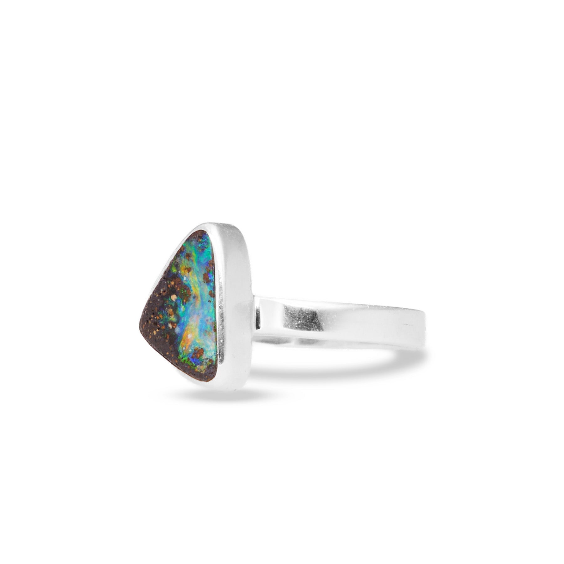 Silver ring with an opal stone on a white background.